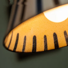 Load image into Gallery viewer, Close-up of a pendant light with black patterns on a dark background