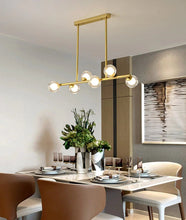 Cargar imagen en el visor de la galería, 6 bulb clear glass globe horizontal modern chandelier with brass accents