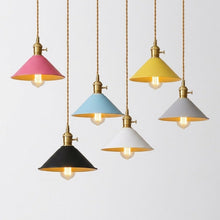 Load image into Gallery viewer, Five hanging pendant lights with cone-shaped shades in pink, yellow, light blue, white, and black, each with a gold-toned metal fixture and cord, shown against a plain light gray background.
