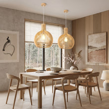 Cargar imagen en el visor de la galería, Dining room with wooden table and chairs, pendant lights, and large windows.
