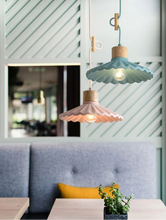 Load image into Gallery viewer, Two pendant lights hanging above a table with a plant in a restaurant setting.
