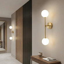 Load image into Gallery viewer, Modern wall lights in a stylish interior setting with a wooden console table.
