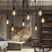 Load image into Gallery viewer, Spider chandelier in black with eight clear glass globes and edison light bulbs
