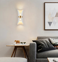 Load image into Gallery viewer, white sconce with gold band in living room space
