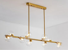 Load image into Gallery viewer, 10 bulb clear glass horizontal chandelier in brass
